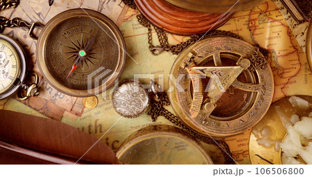 Vintage style travel and adventure. Vintage old compass and other vintage items on the table. Vintage style travel and adventure. Vintage old compass and other vintage items on the table. 106506800