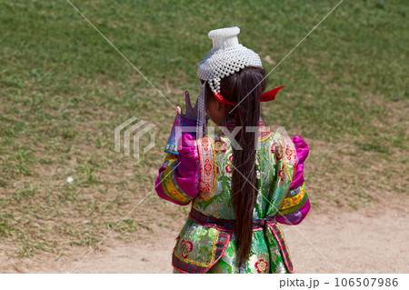 Girl in traditional clothes in front of Erdene Zuu Monastery in Kharkhorin 106507986