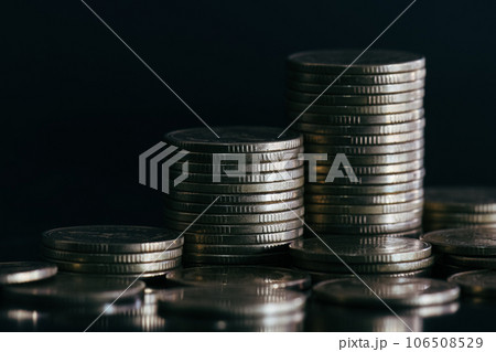 Close up of silver money coin stack on black background with selective focus. Financial background. Close up of silver money coin stack on black background with selective focus. Financial background. 106508529