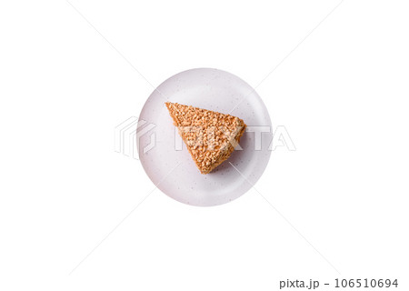 Delicious sweet puff waffle cake with cream and nuts cut into pieces 106510694