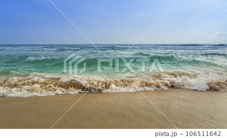 砂浜に打ち寄せる波と青い海 106511642