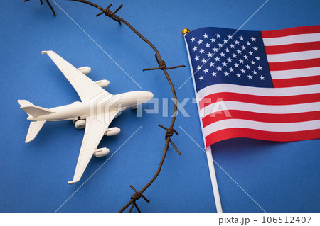 USA closed airspace concept, toy plane, barbed wire and flag on blue background 106512407
