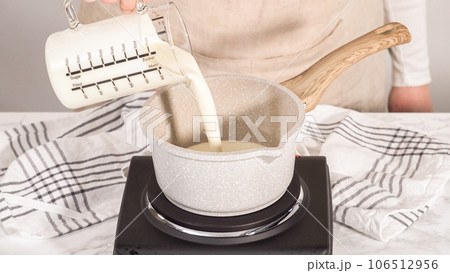 Step by step. Preparing chocolate ganache in a small saucepan. Step by step. Preparing chocolate ganache in a small saucepan. 106512956