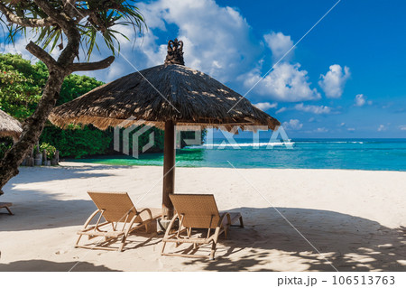 Chairs and umbrella at beach with blue ocean. Holiday banner Chairs and umbrella at beach with blue ocean. Holiday banner 106513763