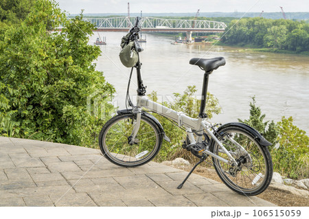 lightweight folding bike on a high shore of the Missouri River above Katy Trail overseeing bridge construction near Rocheport, MO in summer scenery lightweight folding bike on a high shore of the Missouri River above Katy Trail overseeing bridge construction near Rocheport, MO in summer scenery 106515059