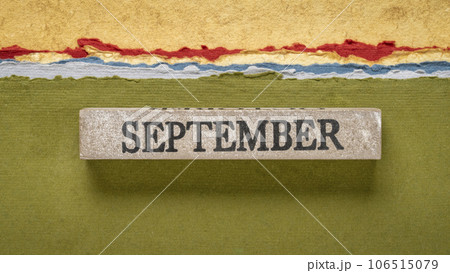 September text on grunge wooden block against handmade rag papers, calendar concept 106515079