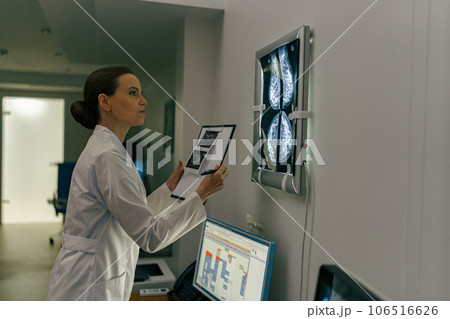 Side view of professional doctor radiologist analyzing scan MRI images in medical center 106516626