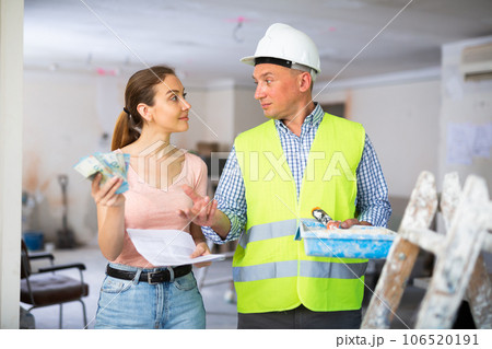 Man builder receiving money from woman employer 106520191