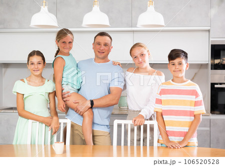 Portrait of best dad who spends his free time with cute, adorable kids in bright modern home kitchen 106520528
