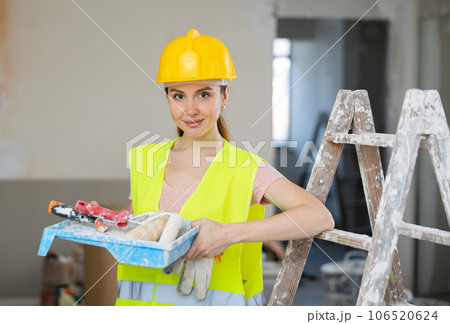 Woman painter posing in house being renovated 106520624