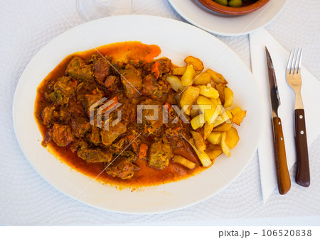 Close up of delicious baked in sauce pork cheeks served with potatoes Close up of delicious baked in sauce pork cheeks served with potatoes 106520838