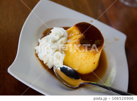Caramel flan with whipped cream 106520906