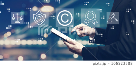 Copyright concept with businessman using a tablet Copyright concept with businessman using a tablet 106523588