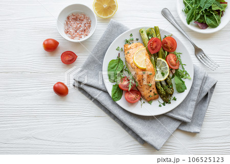 Baked Delicious salmon, green asparagus on  plate 106525123