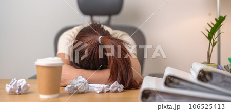 Stressed Asian woman having Tired and Sleepy while working, female businesswoman having headache at office, Exhausted woman with documents folder stack at home late night. Overworked and Overtime 106525413