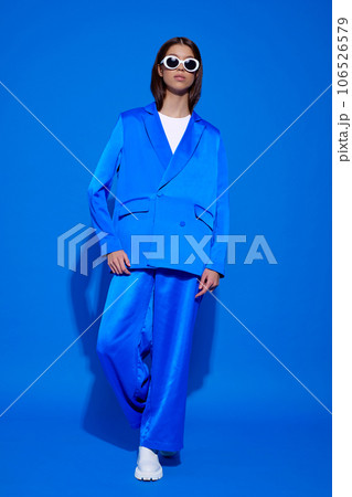 Fashion asian female model in blue suit, white boots and sunglasses. Fashion asian female model in blue suit, white boots and sunglasses. 106526579