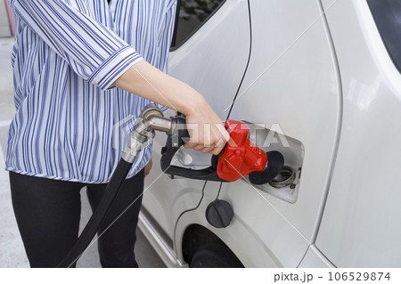 ガソリンスタンドで車に給油する人 106529874