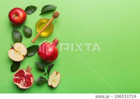 Flat lay composition with symbols jewish Rosh Hashanah holiday attributes on colored background, Rosh hashanah concept. New Year holiday Traditional. Top view with copy space Flat lay composition with symbols jewish Rosh Hashanah holiday attributes on colored background, Rosh hashanah concept. New Year holiday Traditional. Top view with copy space 106531724