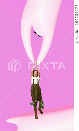 Contemporary art collage. Minimal picture of little girl dressed retro flying with strange white hhost isolated pink background. 106533377