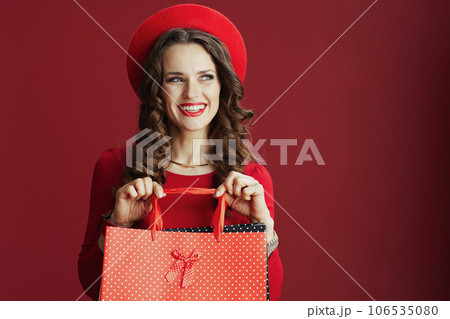 smiling stylish female in dress and beret on background 106535080