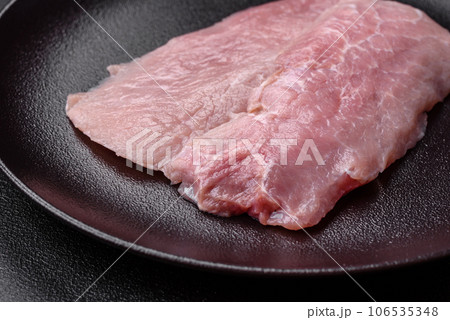 A piece of fresh juicy raw pork with salt, spices and herbs A piece of fresh juicy raw pork with salt, spices and herbs 106535348