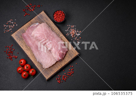A piece of fresh juicy raw pork with salt, spices and herbs A piece of fresh juicy raw pork with salt, spices and herbs 106535375