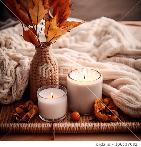 Fall aesthetics, autumn interior decor with cozy blanket and burning candles Fall aesthetics, autumn interior decor with cozy blanket and burning candles 106537082