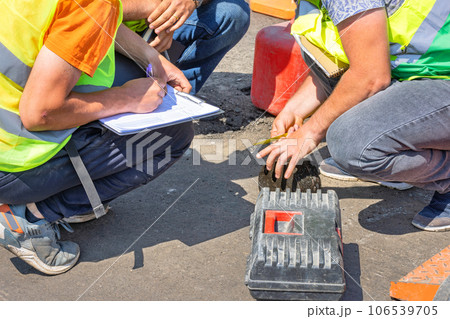 Road engineers measure the thickness of the laid asphalt and record the data in a spreadsheet. Road engineers measure the thickness of the laid asphalt and record the data in a spreadsheet. 106539705