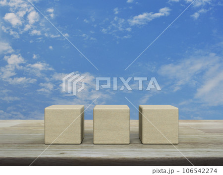 Three wood block cubes on wooden table 106542274