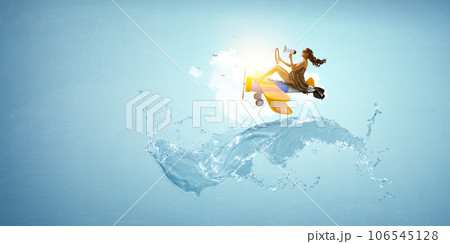 Woman flying on top of the plane Woman flying on top of the plane 106545128