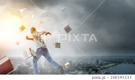 Businessman running among chaos . Mixed media 106545333