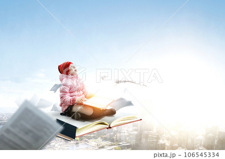 Little girl reading a book 106545334