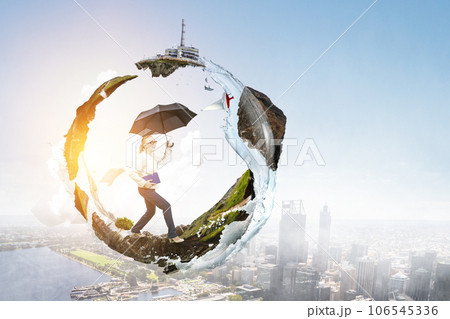 Businesswoman running with umbrella . Mixed media 106545336