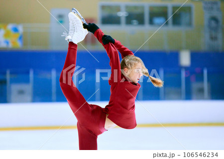 Talented, flexible girl in motion, figure skating athlete in red sportswear training on ice rink arena. Championship preparation 106546234