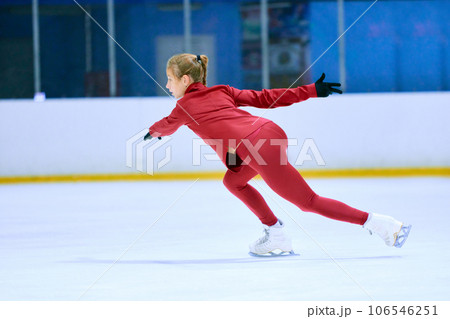 Teen girl, motivated figure skating athlete in motion, training, doing exercises on ice rink arena. Sport education 106546251
