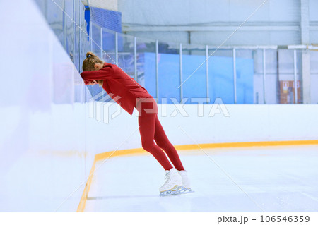 Ups and downs. Challenges. Girl, figure skating athlete feeling tired and exhausted after hard training session on ice rink arena Ups and downs. Challenges. Girl, figure skating athlete feeling tired and exhausted after hard training session on ice rink arena 106546359