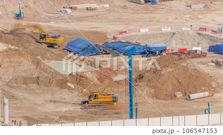Pile driving in foundation pit for construction of apartment complex building aerial timelapse in UAE 106547153