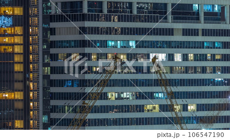 Office and residential buildings windows illuminated at night timelapse 106547190