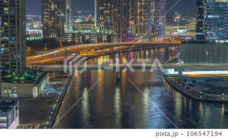 Walking promenade along water canal in Business Bay district of Dubai aerial night timelapse. 106547194