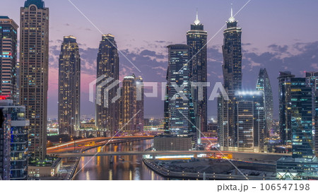 Cityscape with skyscrapers of Dubai Business Bay and water canal aerial day to night timelapse. Cityscape with skyscrapers of Dubai Business Bay and water canal aerial day to night timelapse. 106547198