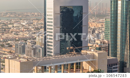 Rooftop swimming pool on the top of skyscraper near Sheikh Zayed Road in Dubai aerial timelapse, UAE. 106547283
