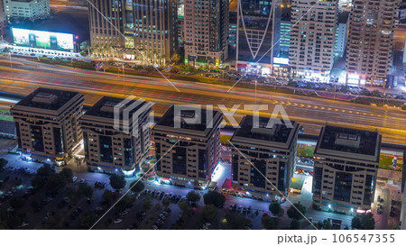 Buildings on Sheikh Zayed Road in Dubai aerial night timelapse, UAE. 106547355