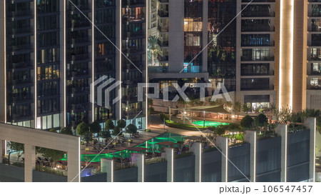 Luxury swimming pool on roof top during amazing evening aerial night timelapse. 106547457