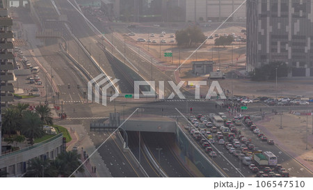 Top aerial view of busy road intersection and traffic junctions in Dubai city timelapse. 106547510