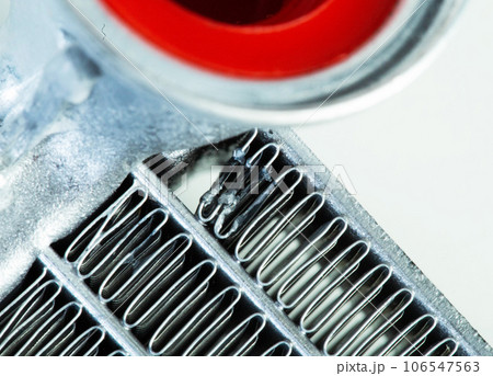 Damaged car heater core. Damaged honeycombs on an aluminum car radiator. Close-up 106547563