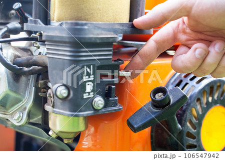 Choke opening switch in carburetor for cold start, close-up 106547942