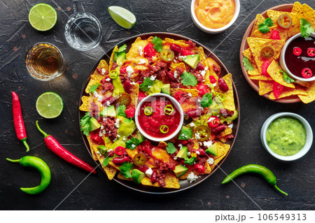 Loaded nachos. Mexican nacho chips with beef, overhead flat lay shot 106549313