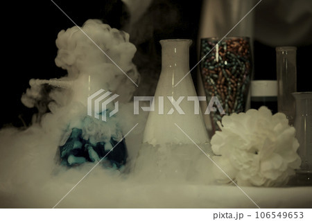 In a chemical laboratory, flasks filled with solutions in smoke. 106549653