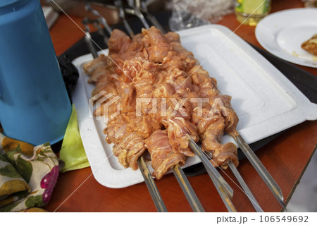 Chicken skewers marinated on skewers and ready to cook. Semi-finished product for barbecue. Chicken skewers marinated on skewers and ready to cook. Semi-finished product for barbecue. 106549692