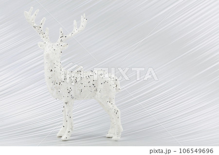 On a silver background, a white Christmas deer. On a silver background, a white Christmas deer. 106549696